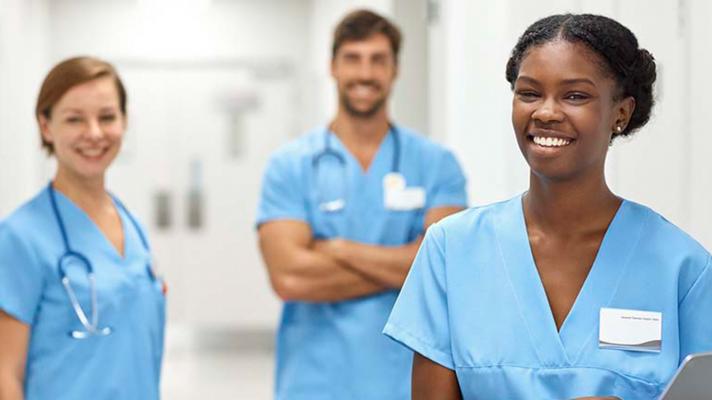 Smiling nurses standing in hospital hallway Smiling nurses standing in hospital hallway